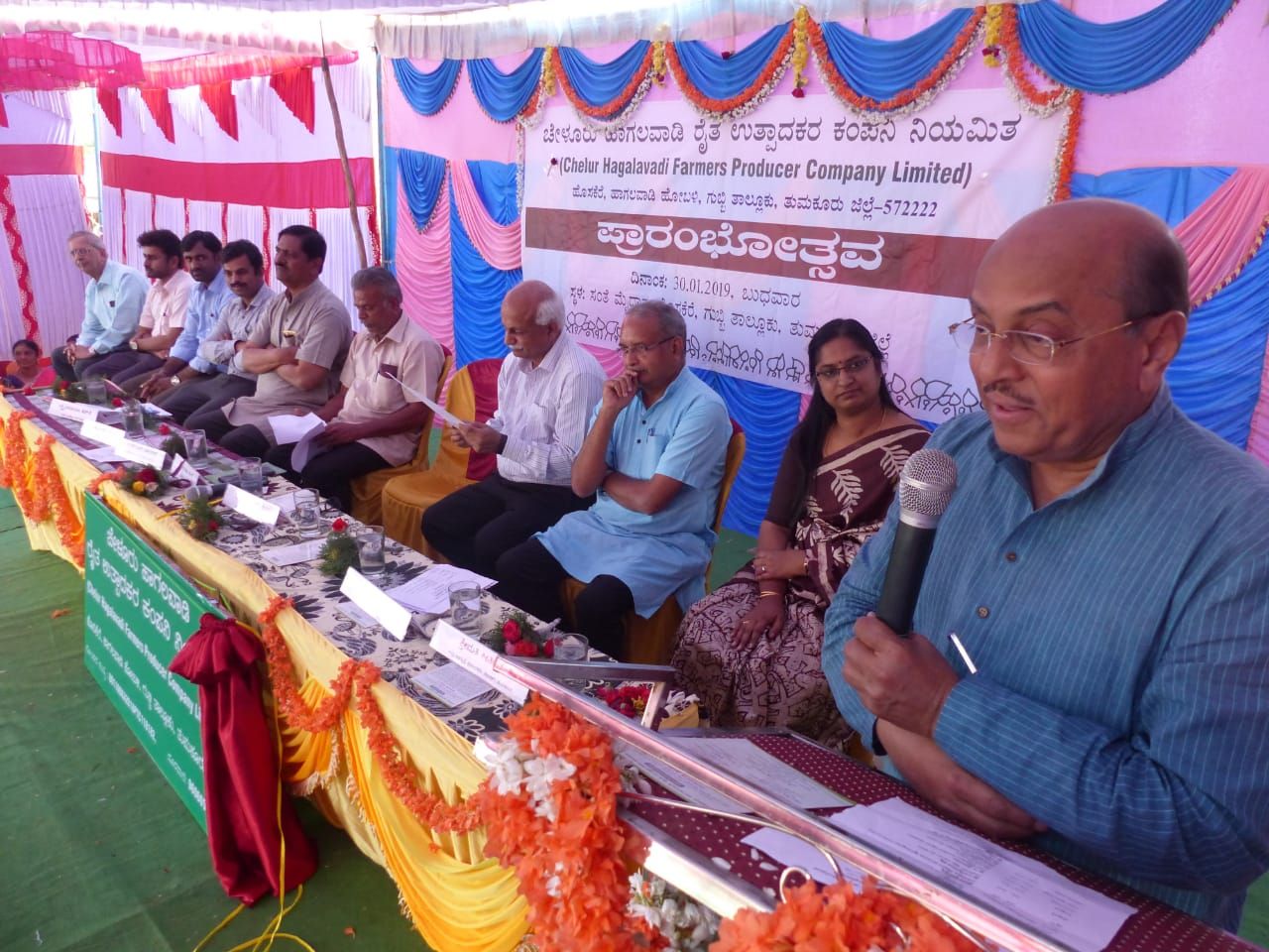 Directors and guests on the dais at a farmer producer company event