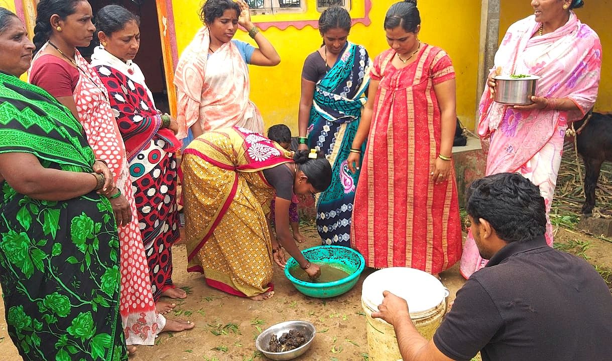Women farmers preparing organic liquid manure