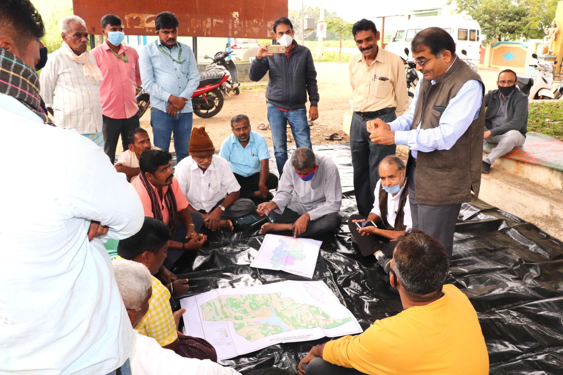 Farmers and IDF staff discussing a village map