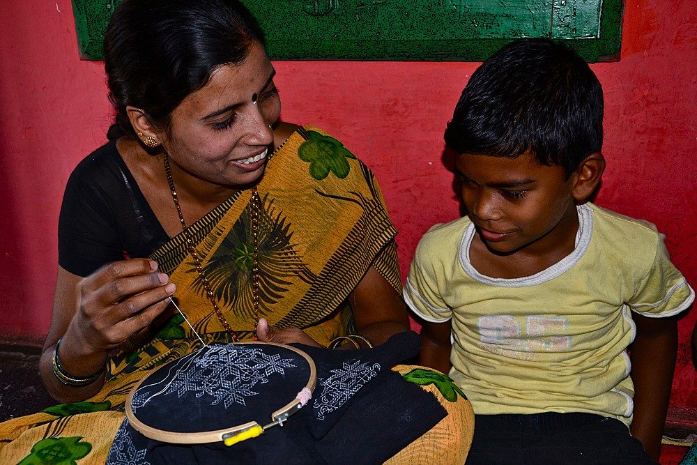 A woman and child at kasuti embroidery